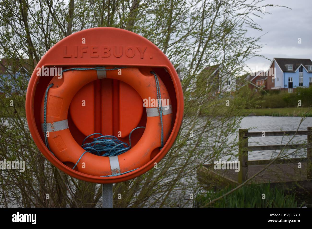 Lifebuoy beside a lake in Milton Keynes with copyspace. Stock Photo