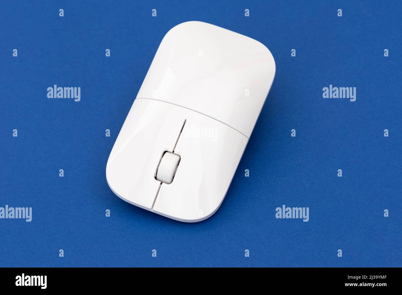 White computer mouse on the blue background. Stock Photo