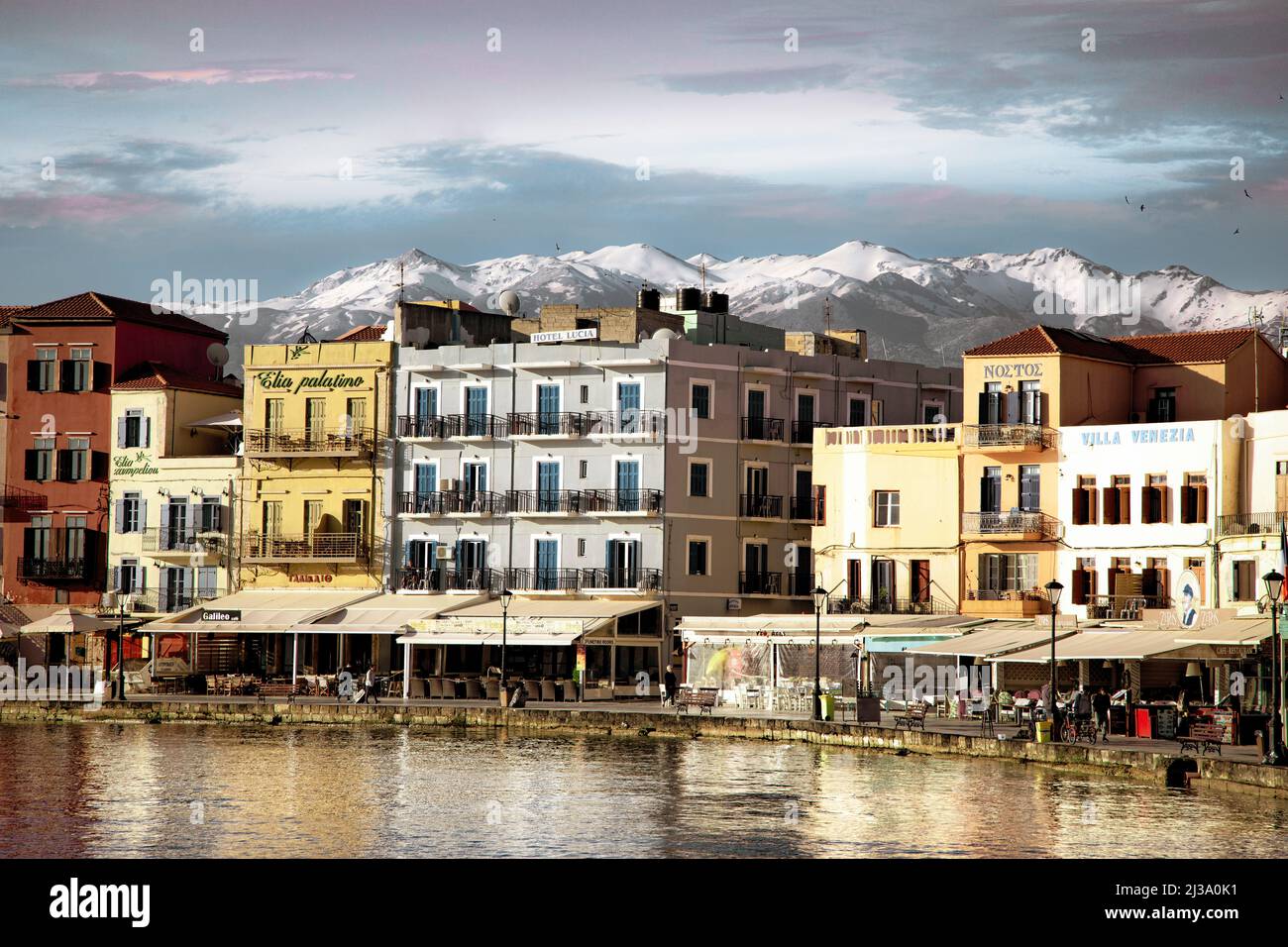 The Venetian harbor front of Chania, Crete with the White Mountains in the background. Stock Photo
