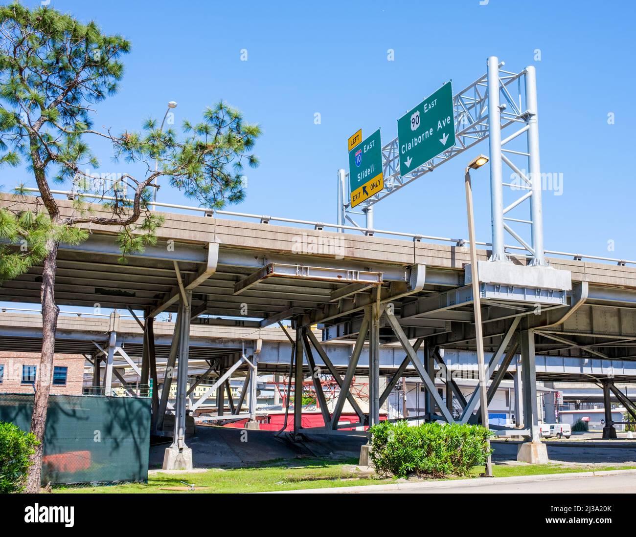 NEW ORLEANS, LA, USA - APRIL 3, 2022: Elevated highway over Claiborne Avenue with road signs for Claiborne Avenue and Sidell Exits Stock Photo
