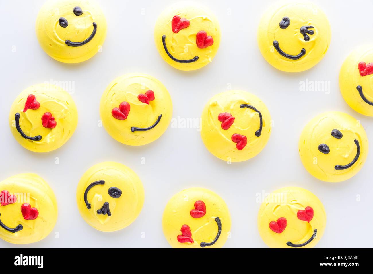 Top down view of several smiley face emoji merengue cookies. Stock Photo