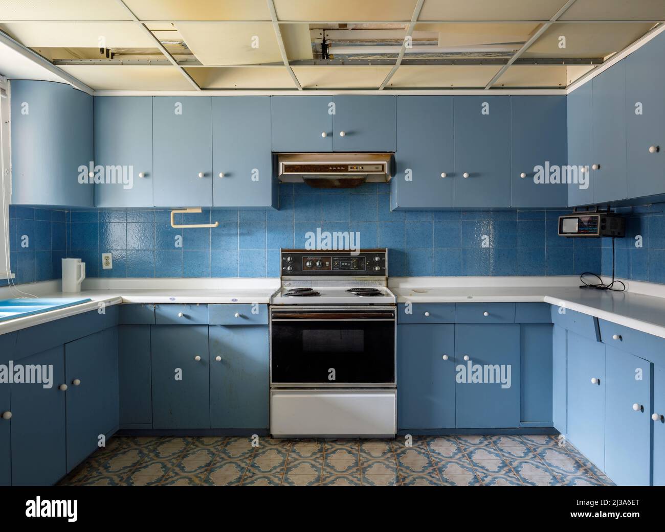 A retro kitchen inside an abandoned house. This house has since been demolished. Stock Photo