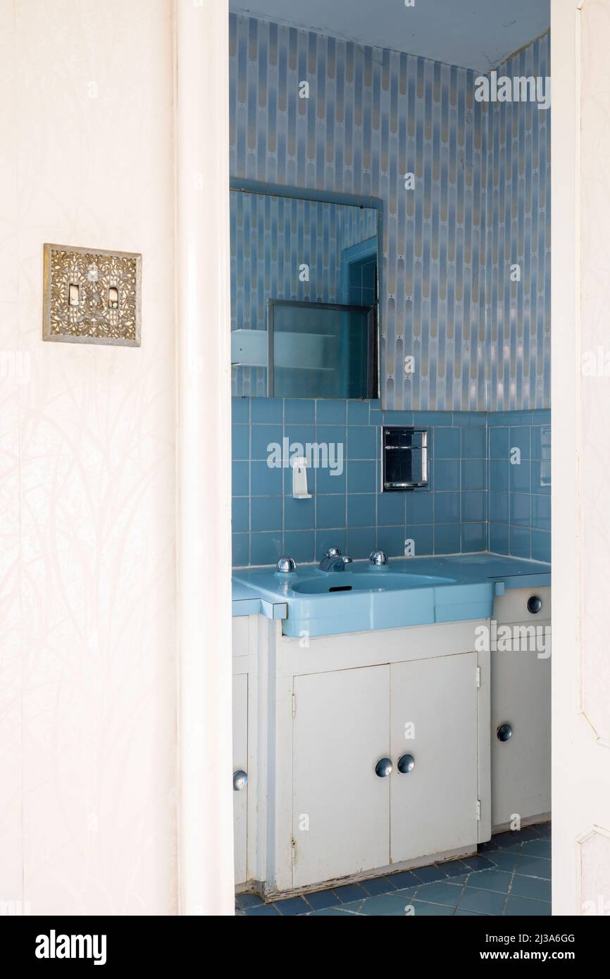 A retro bathroom from the 1960s or 1970s with a blue theme. This house has since been demolished. Stock Photo