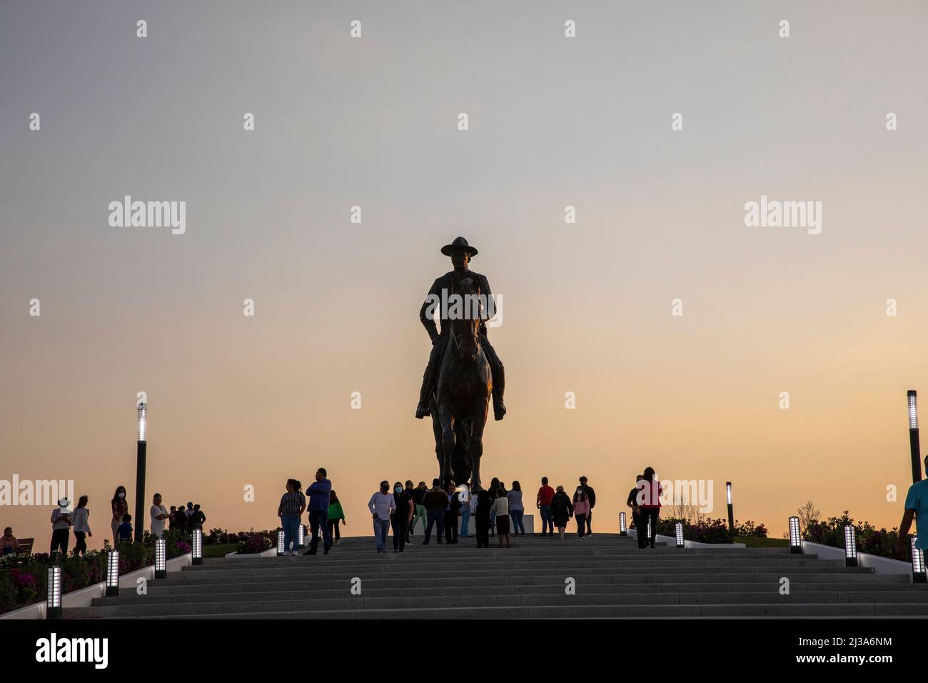 People silhouettes around Felipe Angeles monumental sculpture. This statue is located within the Felipe Angeles International Airport grounds. Stock Photo