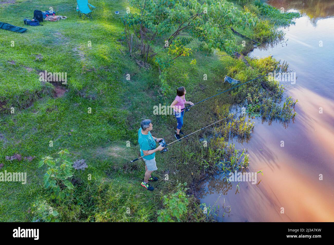 Aerial view of a man and woman fishing on the Tebicuary River in Paraguay. Stock Photo
