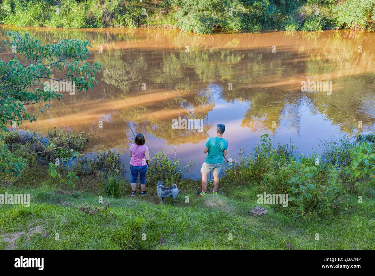 Aerial view of a man and woman fishing on the Tebicuary River in Paraguay. Stock Photo