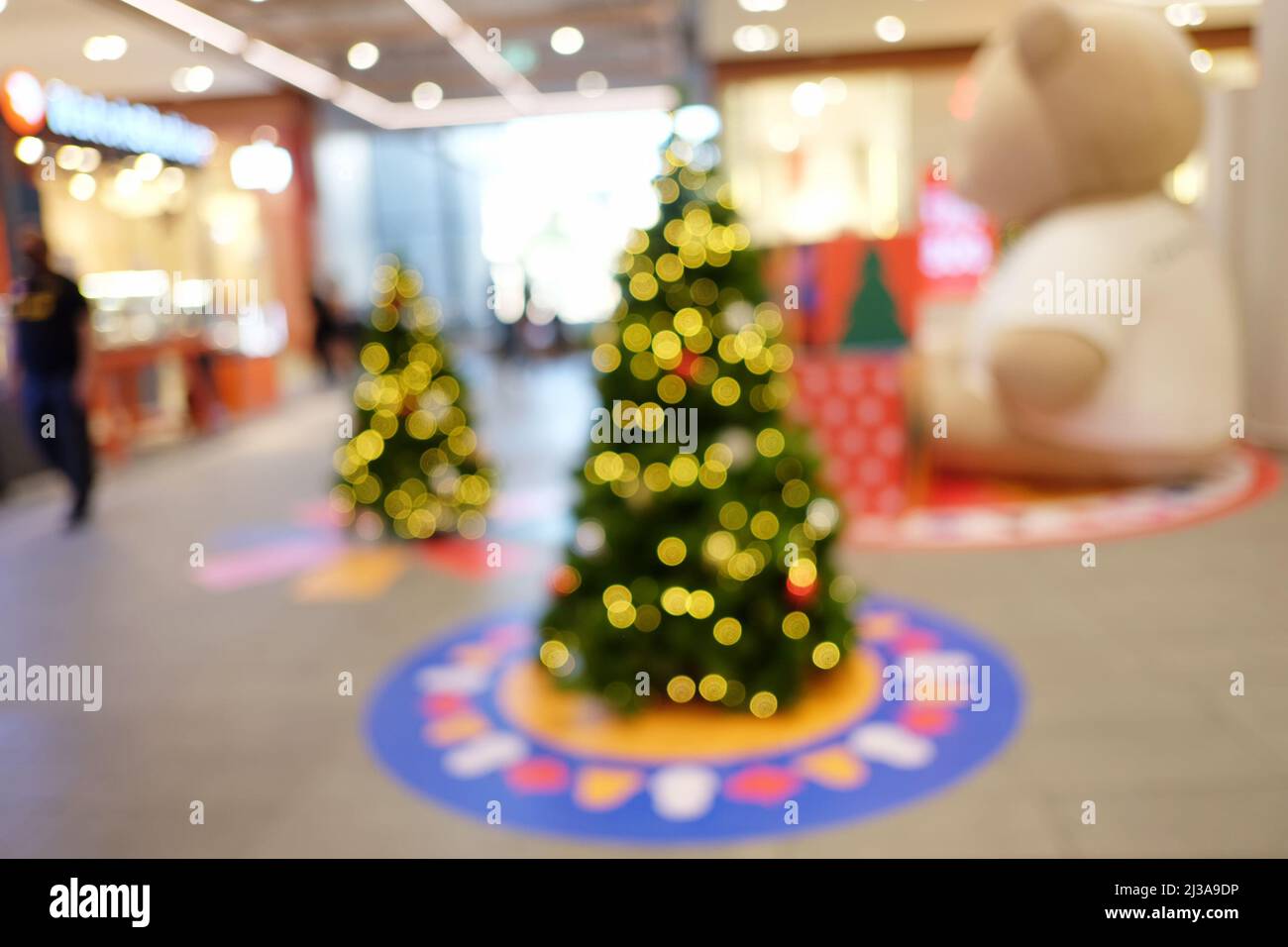 Abstract blur christmas tree background or defocused shopping mall of department store for design in your work backdrop concept. Stock Photo