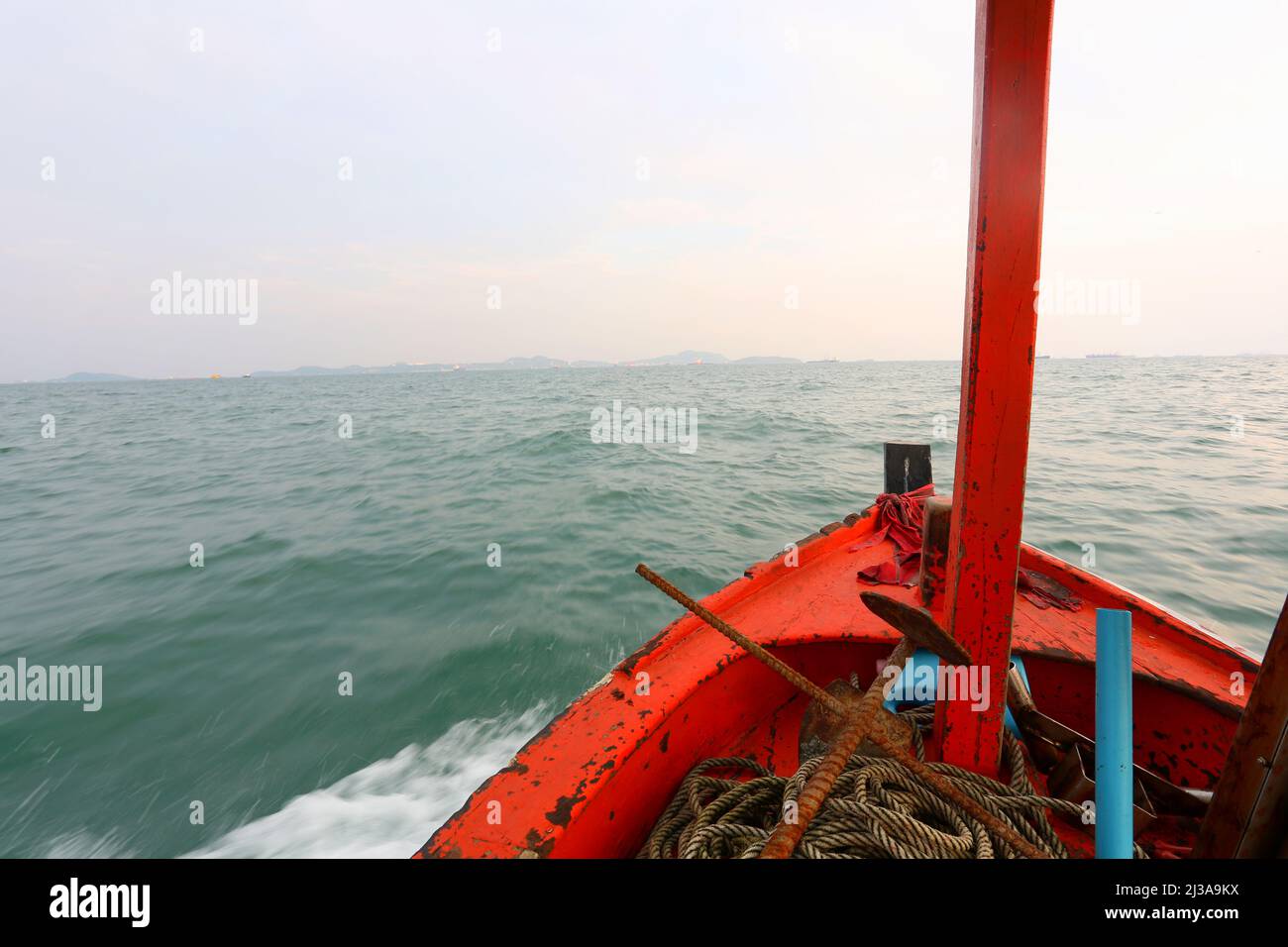 Prow of a small boat was rushing out into the vast sea in front,travel and adventure concept. Stock Photo