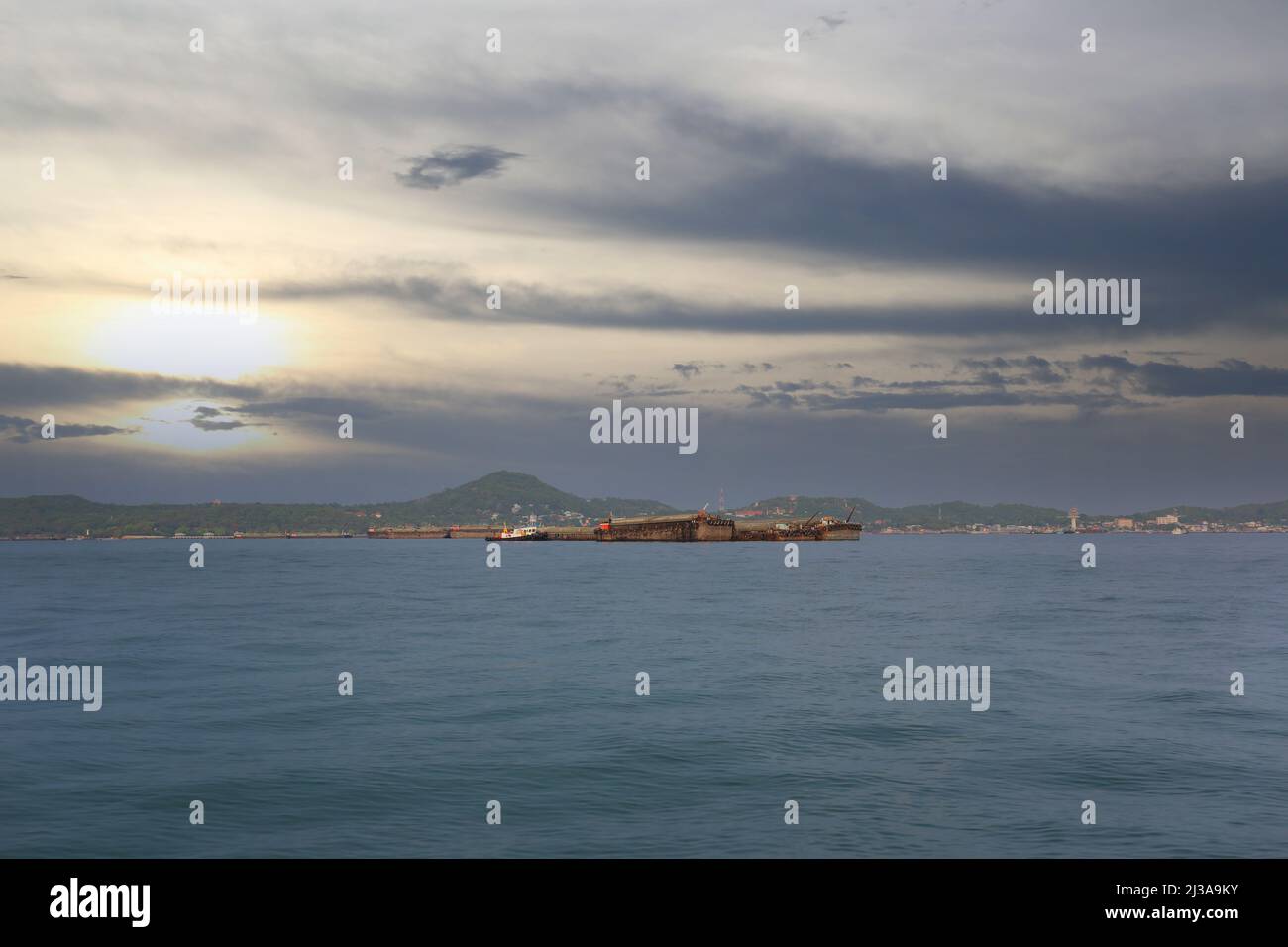 Coastal seas around Koh Sichang, Thailand are crowded with cargo ships on a clear day. Stock Photo