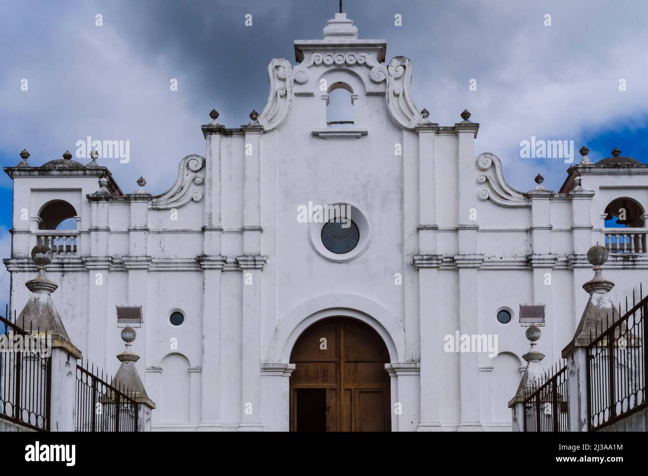 Church in Apaneca, El Salvador. White old church with arched door. Christian house of worship Stock Photo