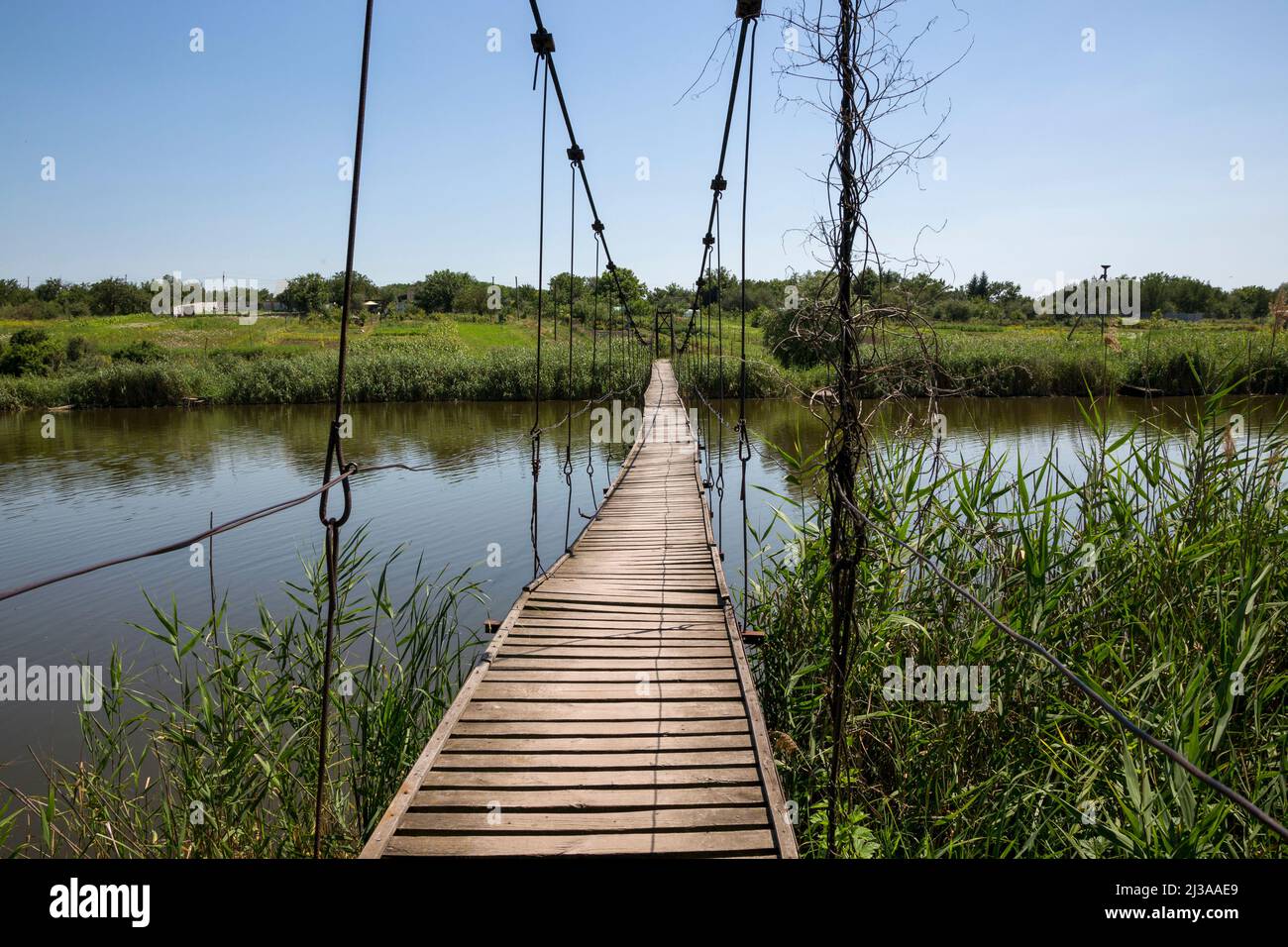 Makeshift wooden bridge over water Stock Photo - Alamy