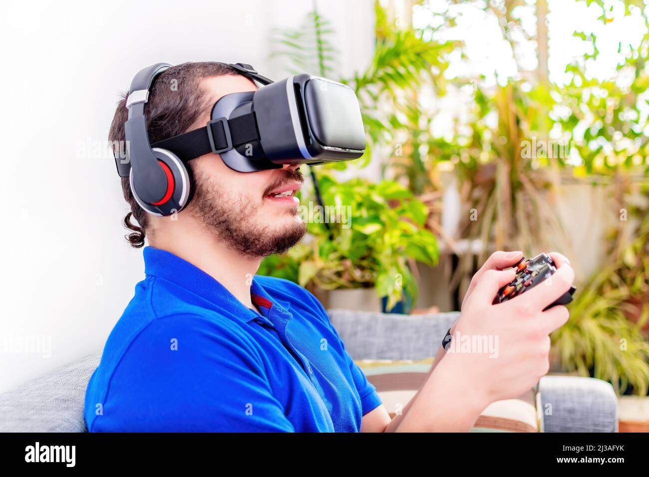 A bearded middle eastern young man using the virtual reality headset ...