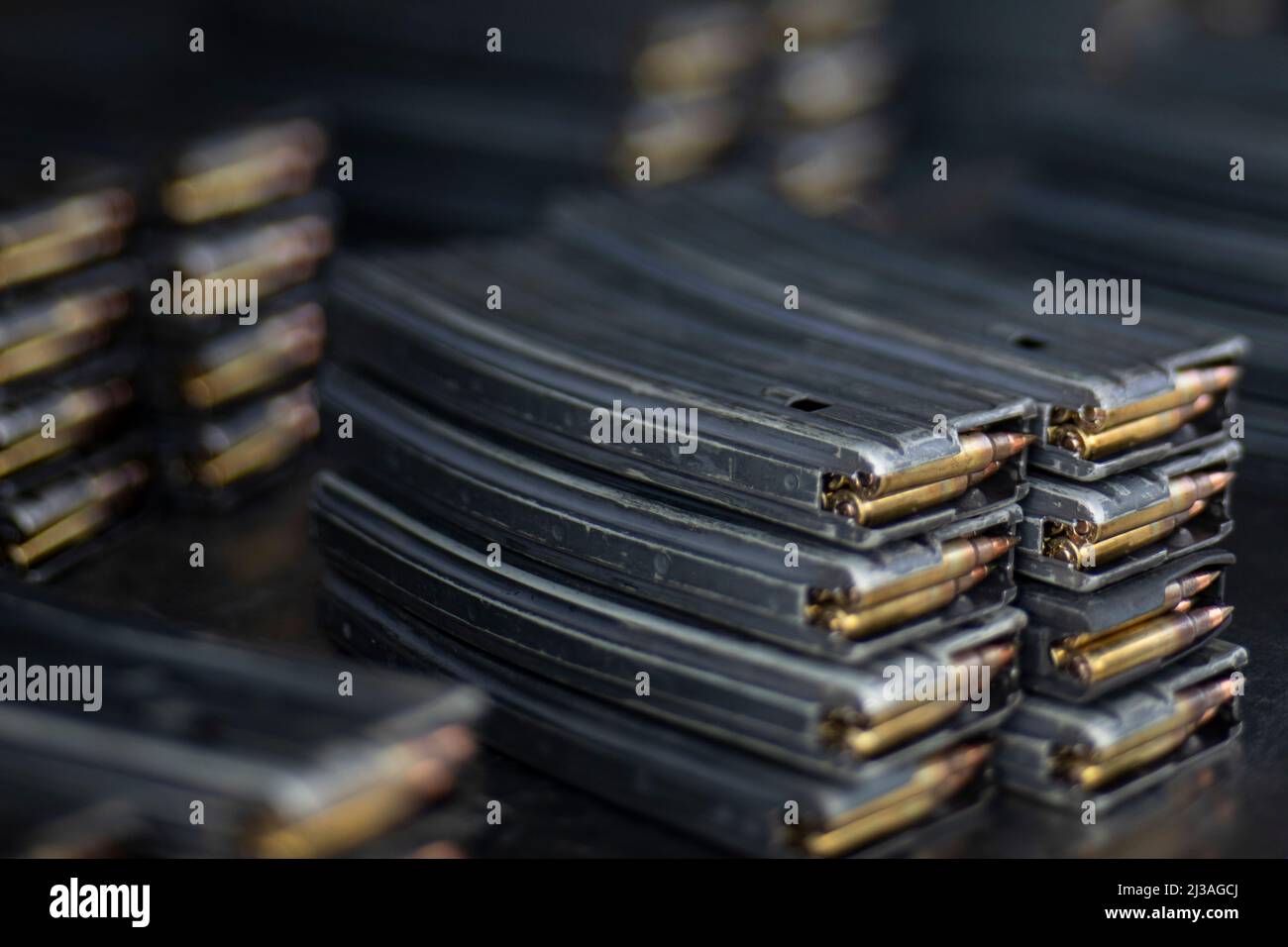 Magazines with 5.56mm ammunition sit on a table at the range during an