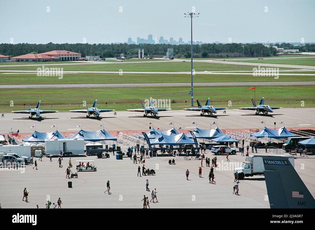 A lineup of F/A-18E Super Hornets assigned to the Blue Angels sit parked on the flight line at MacDill Air Force Base, Florida, March 25, 2022. The Blue Angels headlined Tampa Bay AirFest where an estimated 185,000 members watched various military and civilian aviation displays. (U.S. Air Force photo by Airman 1st Class Joshua Hastings) Stock Photo