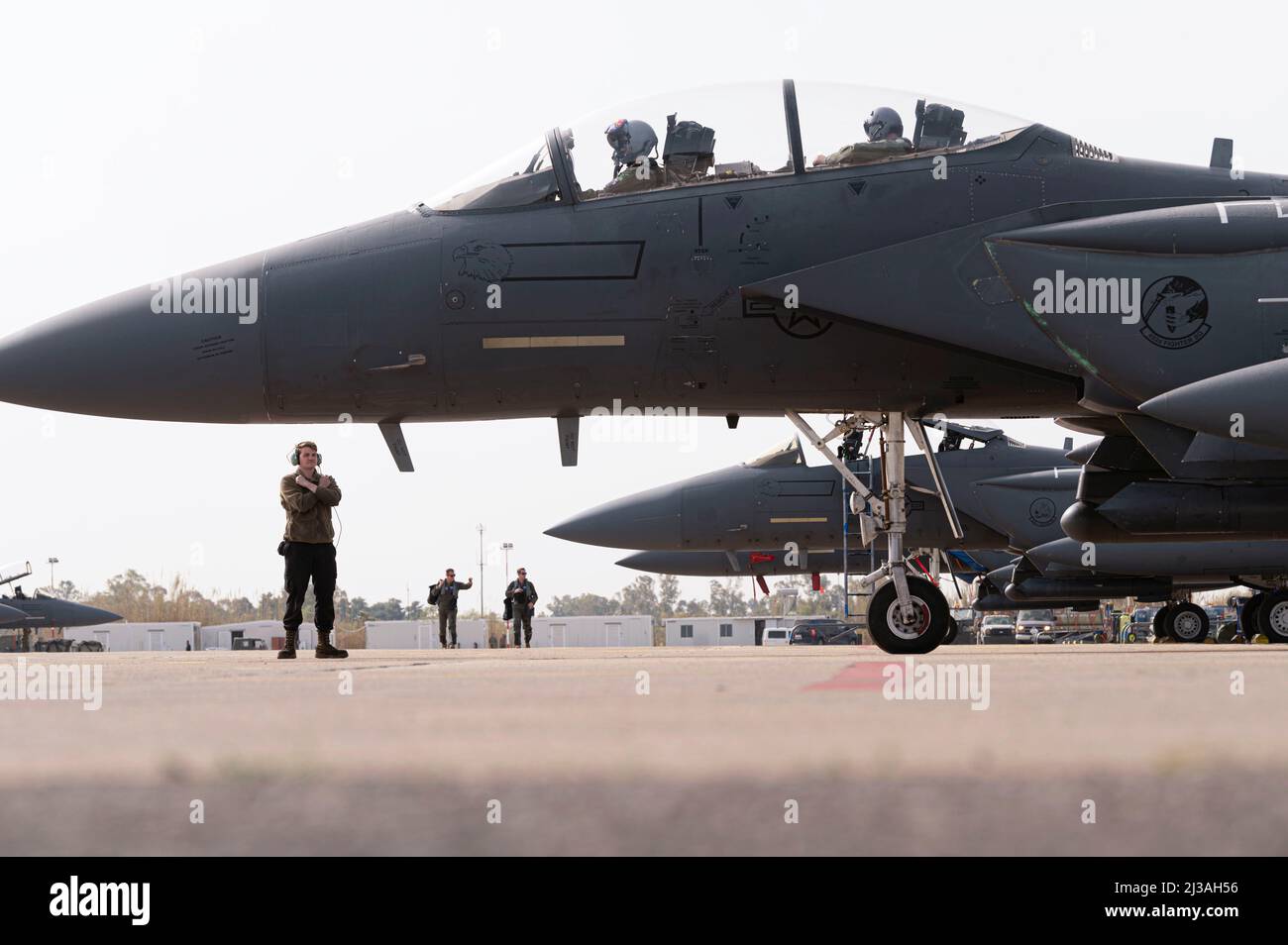 A U.S. Air Force F-15E Strike Eagle pilot and a crew chief assigned to the 492nd Fighter Squadron from Royal Air Force Lakenheath, England communicate before a sortie at Andravida Air Base, Greece, April 5, 2022. The 48th Fighter Wing from Royal Air Force Lakenheath flew alongside the Hellenic air force and other NATO partners during INIOCHOS 22, a Hellenic air force led exercise designed to enhance the interoperability and skills of allied and partner forces in the accomplishment of joint operations and air defenses. (U.S. Air Force photo by Staff Sgt. Malissa Lott) Stock Photo