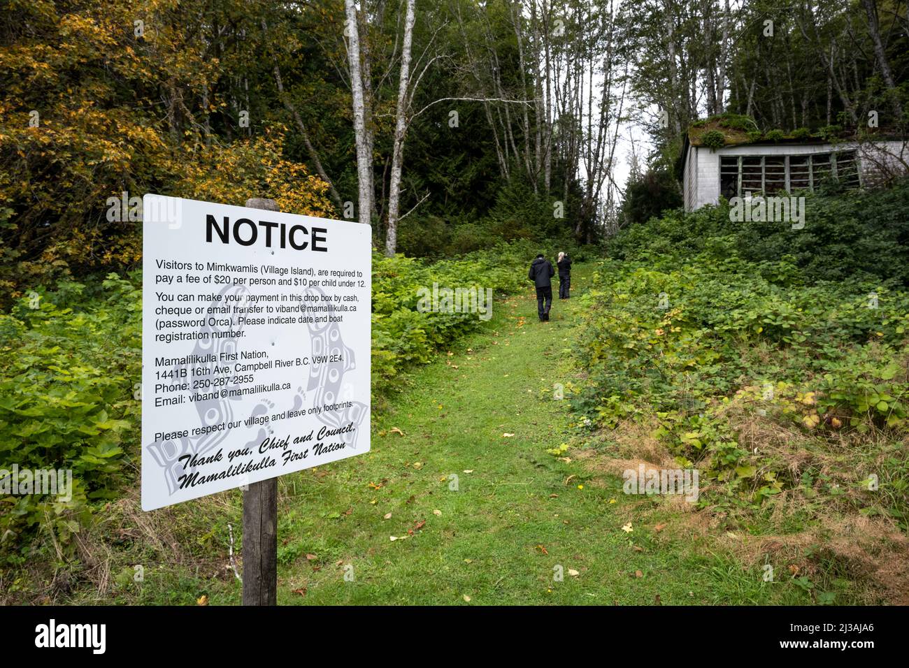A notice signage on the side of a trail to an old village site near