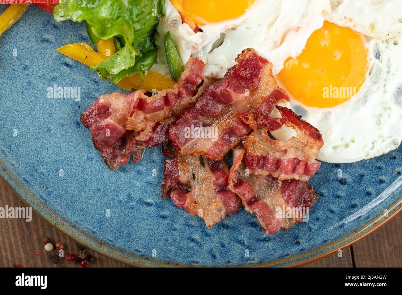 Closeup on fried bacon with eggs breakfast Stock Photo