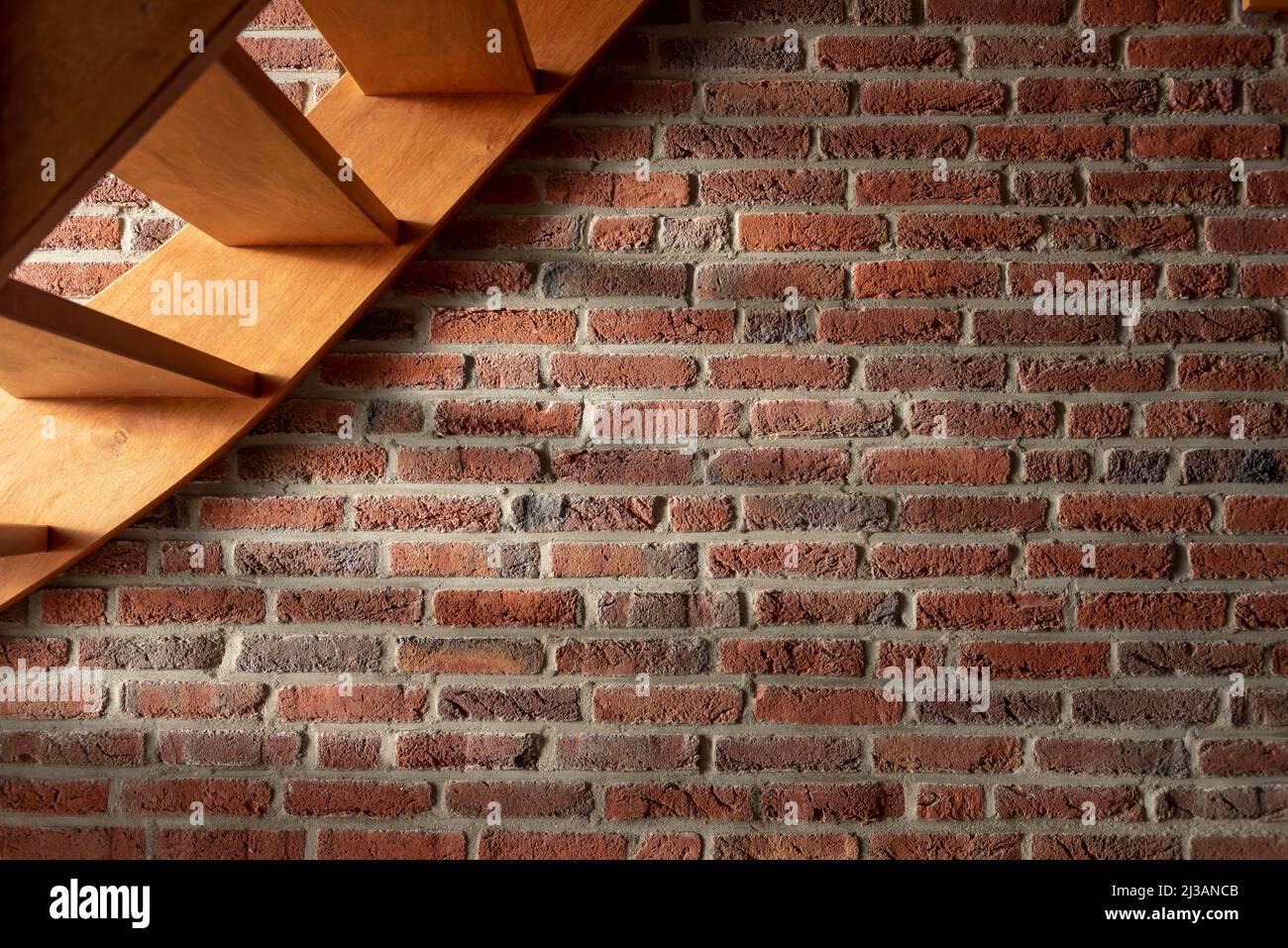 Red brick wall under the stairs Stock Photo Alamy