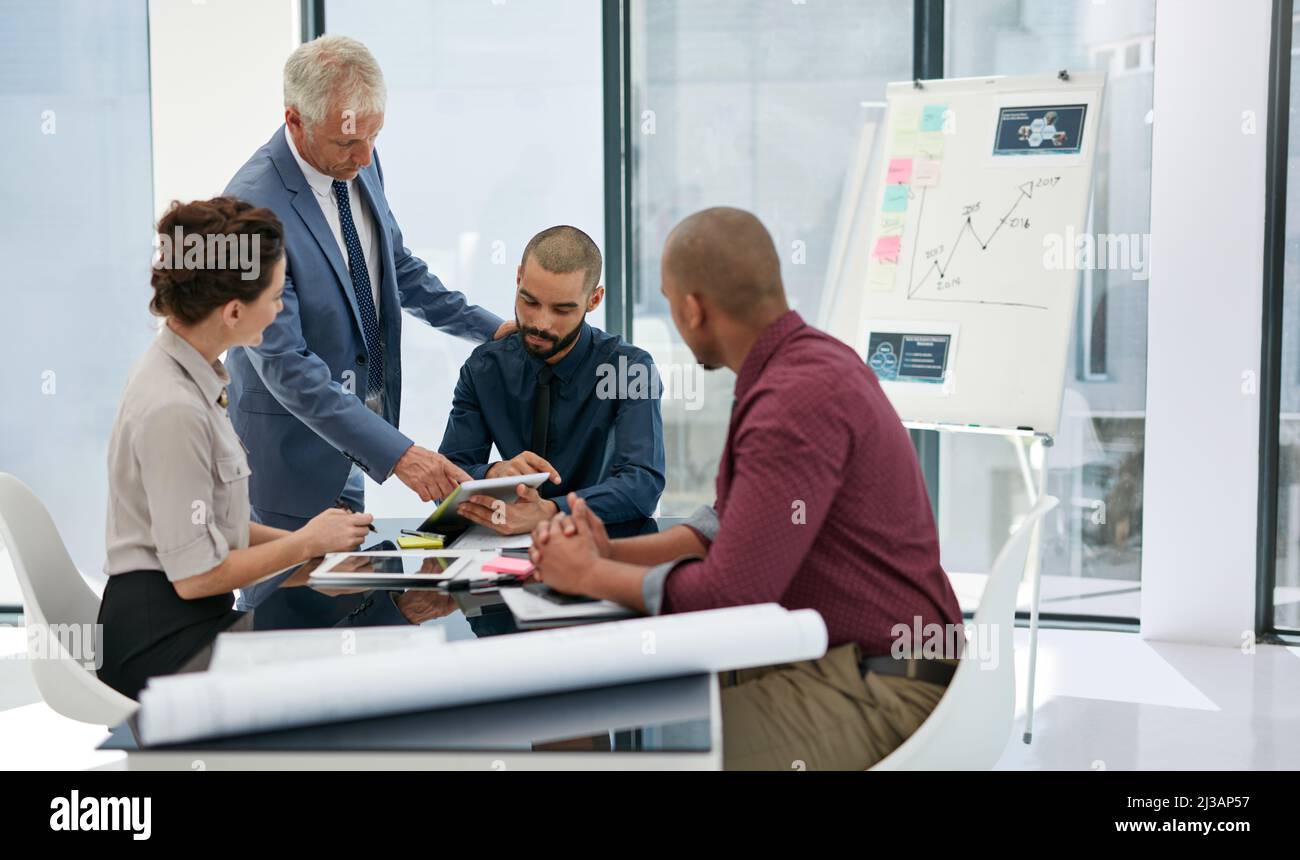 Giving his expert opinion. Shot of businesspeople working in an office. Stock Photo