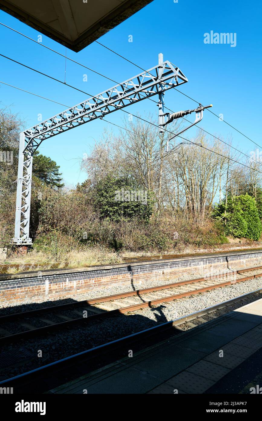 Electric rail track at the railway station in Corby, England Stock