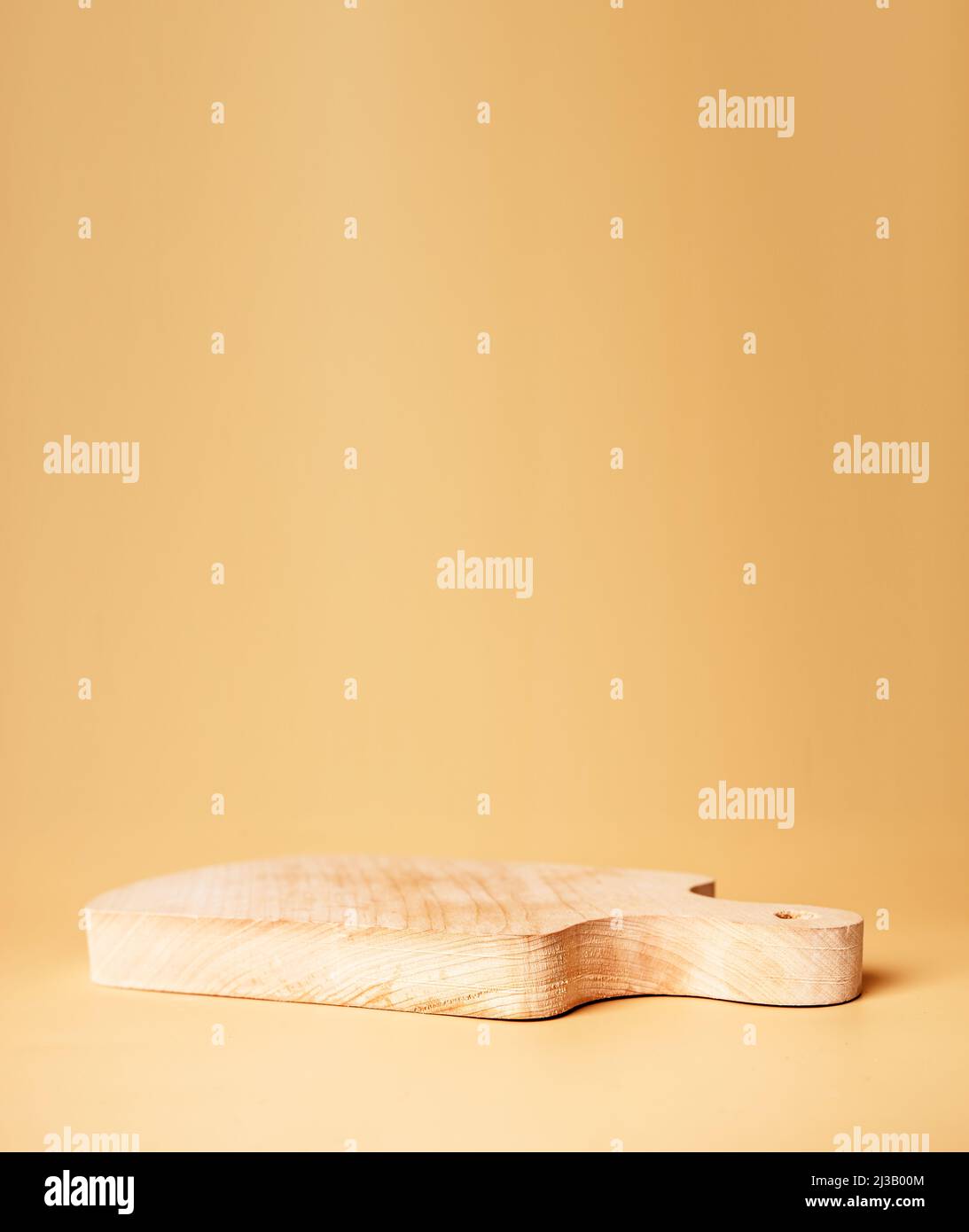 Wooden cutting board. Product pedestal for food display. Podium on beige background. High quality photo Stock Photo