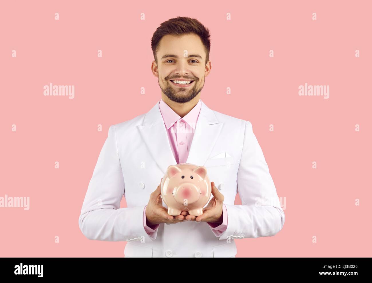 Smiling man hold piggybank for money saving Stock Photo