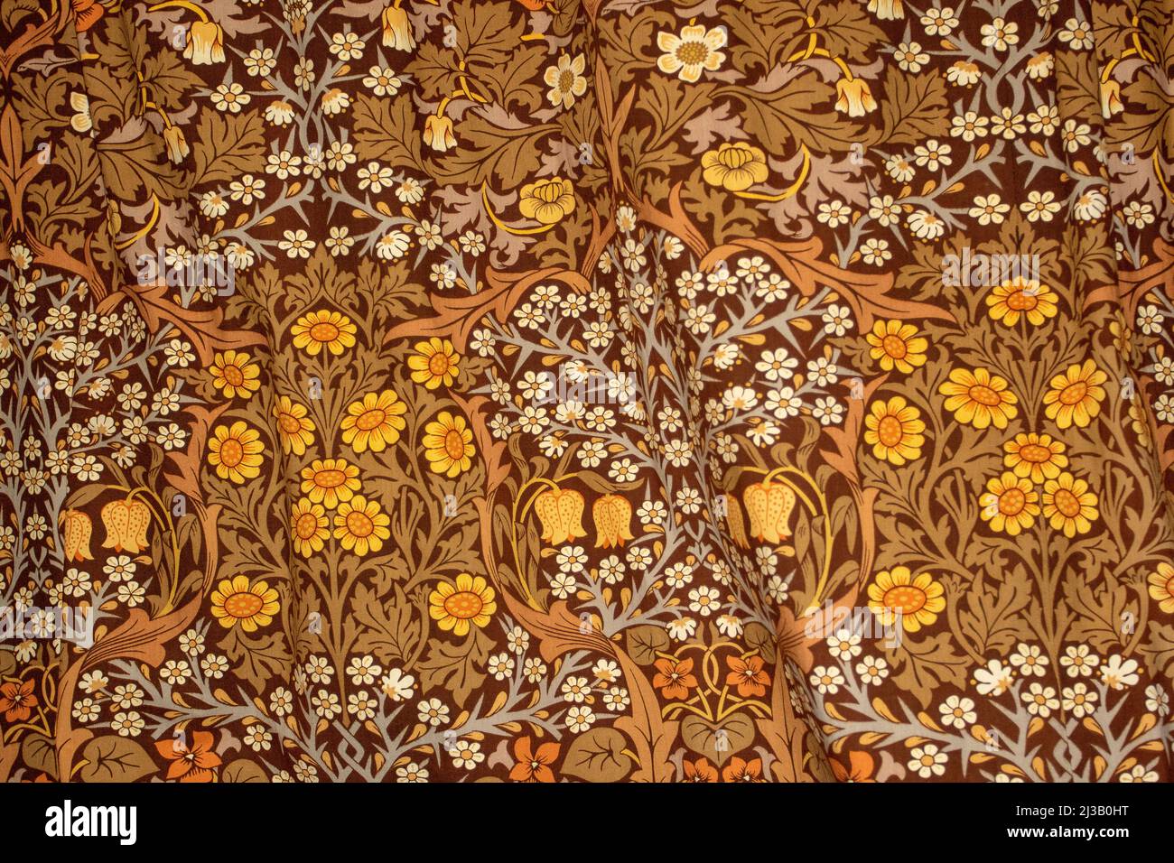 Charming Victorian style floral fabric design in muted brown and yellow earth colours Stock Photo