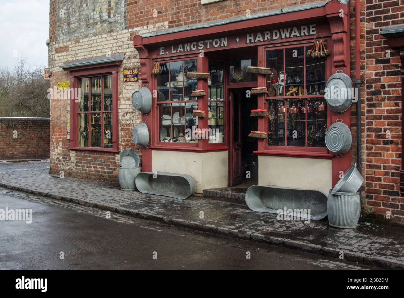 Exterior of an old fashioned hardware shop, with tin baths on display