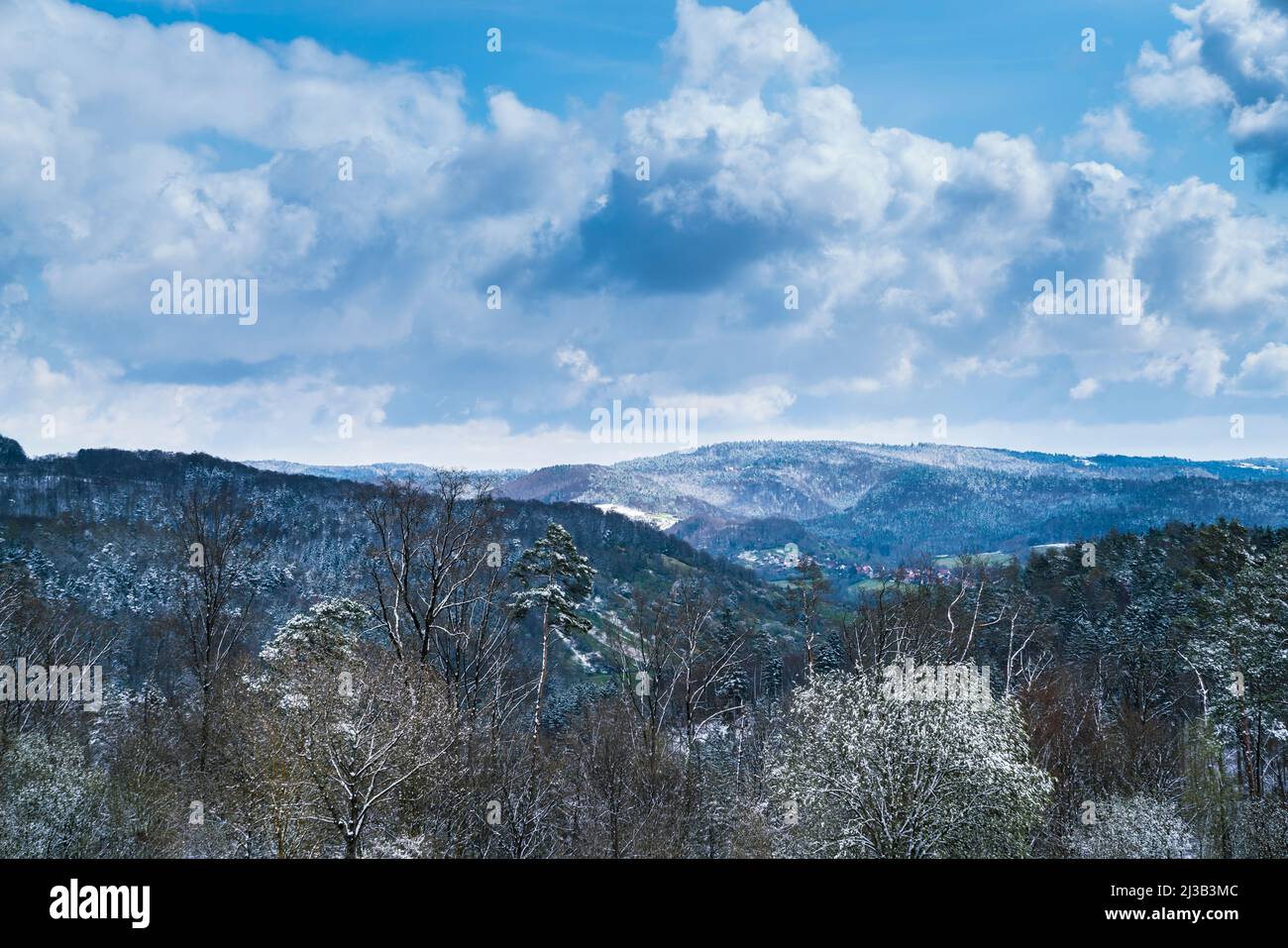 Germany, View above the forest schwaebischer wald above the white snow covered tree tops near rudersberg town houses Stock Photo