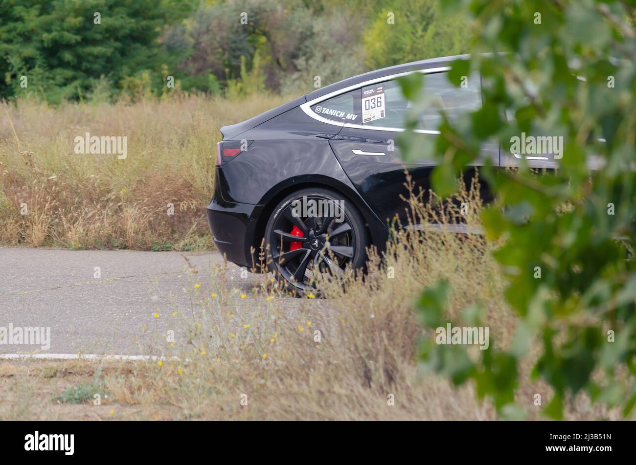 Tesla model 3 spacex edition. Black electric sports car drives at