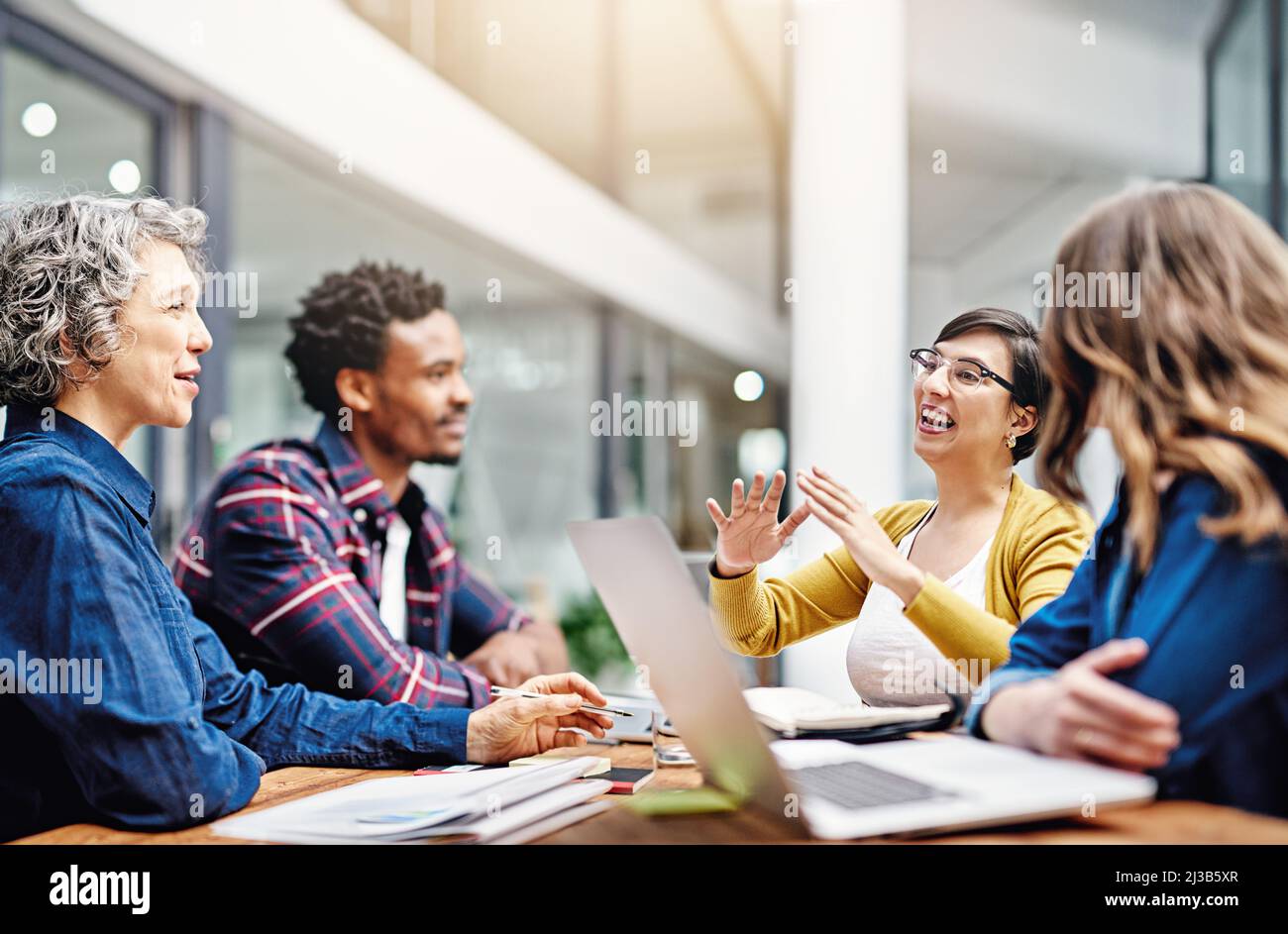 They produce the most dynamic work together. Cropped shot of a group of creatives having a meeting in a modern office. Stock Photo
