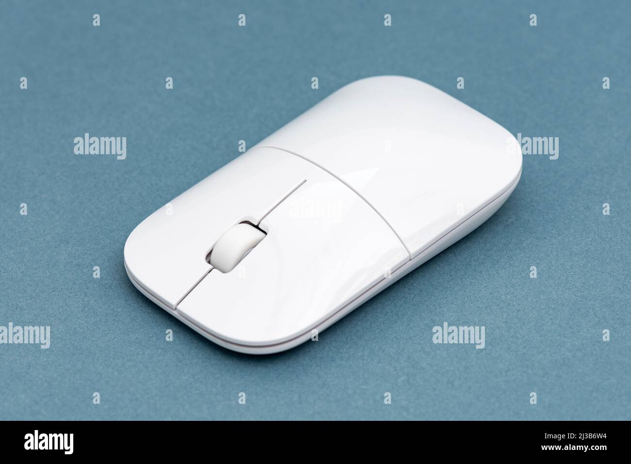 White computer mouse on the blue background. Stock Photo