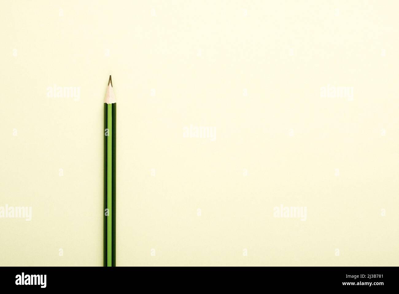 Wooden pencil in green and black colors on cheam white background with ...