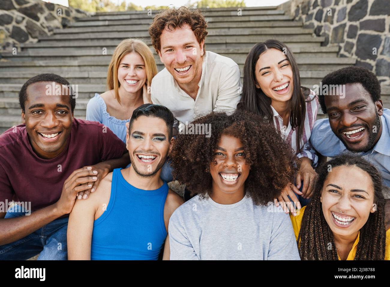 Young diverse people having fun outdoor laughing together - Focus on ...