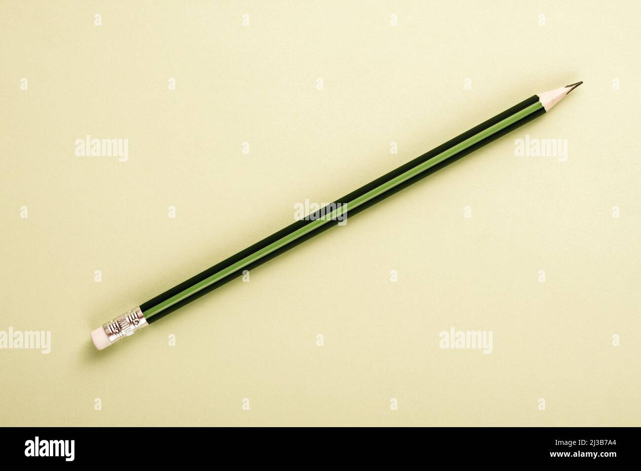 Wooden pencil in green and black colors on cheam white background with ...