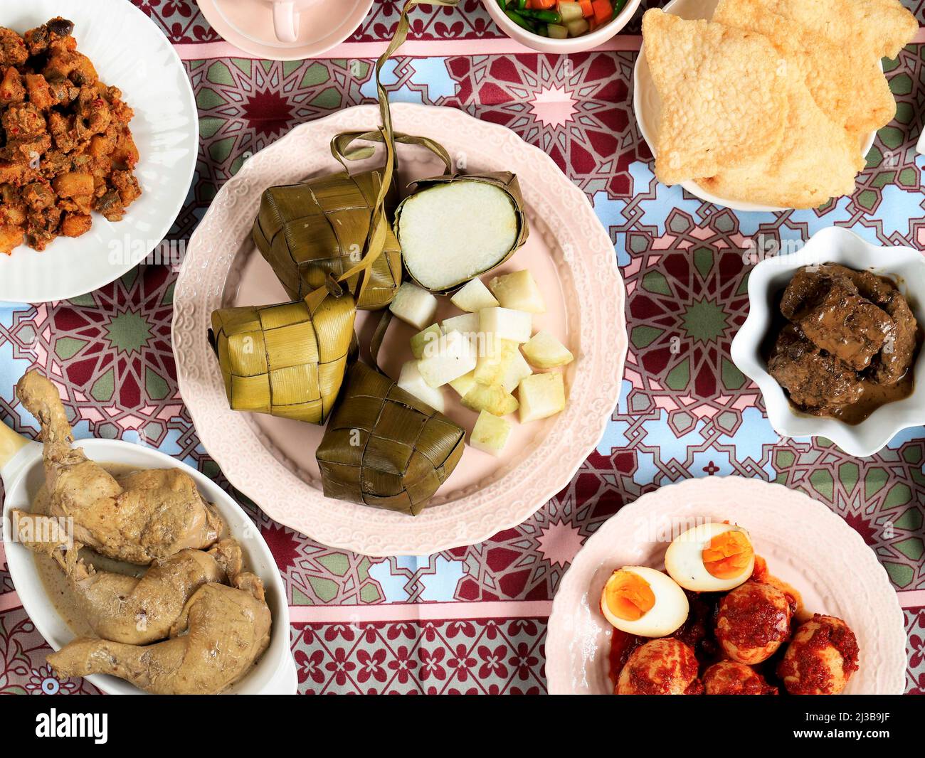 Ketupat Lebaran. Traditional Celebratory Dish of Rice Cake or Ketupat with Various Side Dishes, Popular Served During Eid Celebrations. Stock Photo