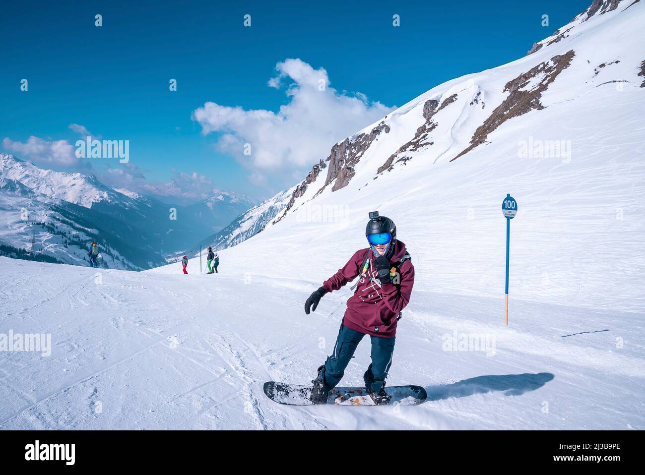 Premium Photo  Young snowboarder sliding down snowy slope on mountain at  winter resort