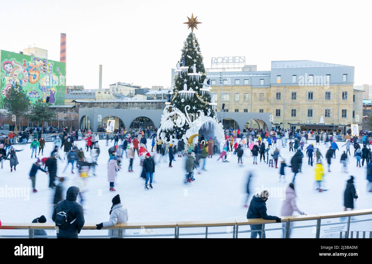 Ukraine, Kyiv - January 7, 2022: Ice skating rink in winter. People are ...