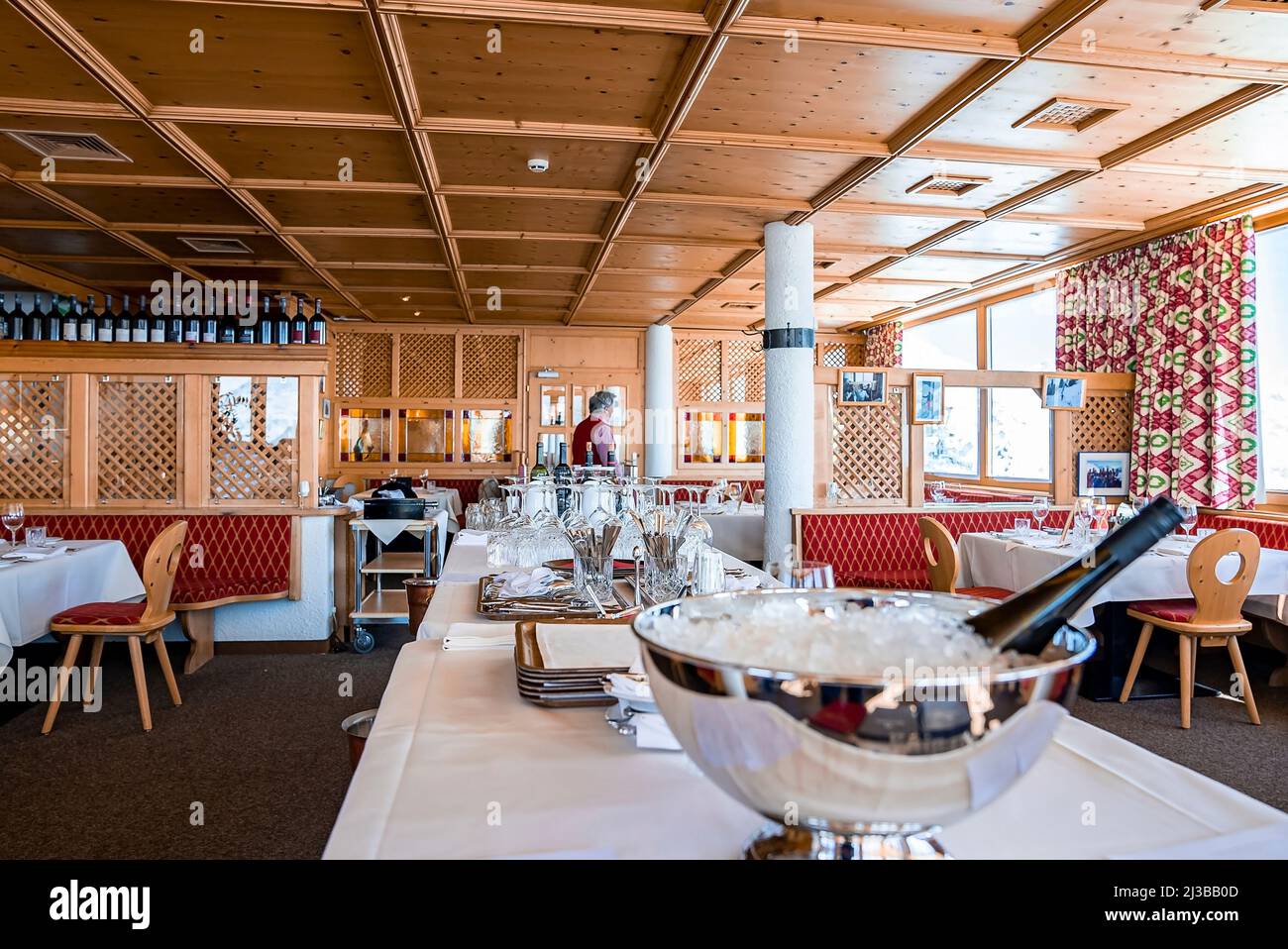 Champagne bottle in ice bucket on table with elegant place setting in
