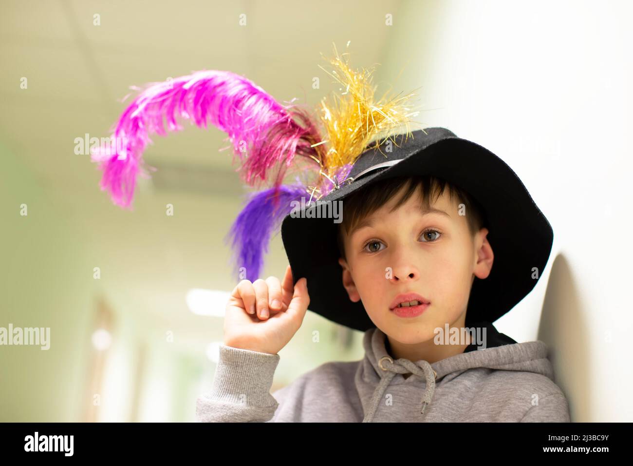 Little boy in a theater hat with feathers. Young artist from the theater studio Stock Photo Alamy