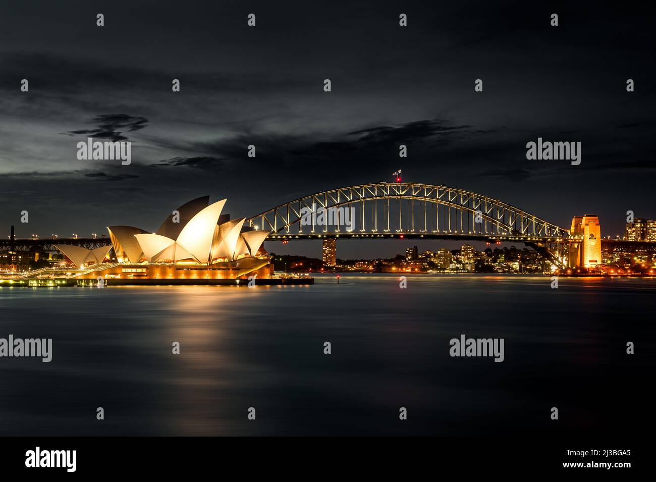 Famous Sydney Opera House with Harbour Bridge at night. Stock Photo