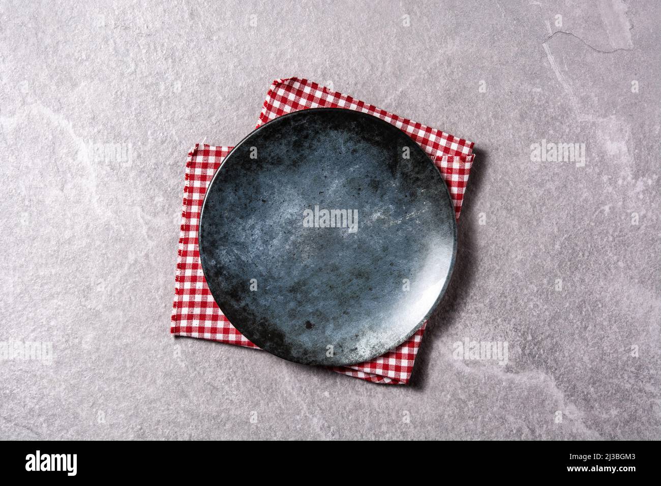 Black and blue empty plate on gray background Stock Photo