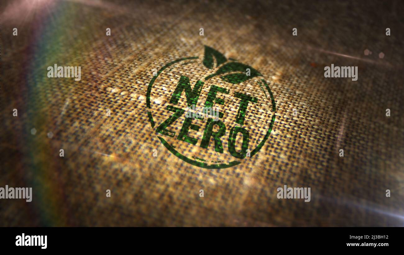 Net zero and eco friendly symbol stamp printed on linen sack. Co2 neutral, ecology, environment, carbon emissions reduction and green energy concept. Stock Photo