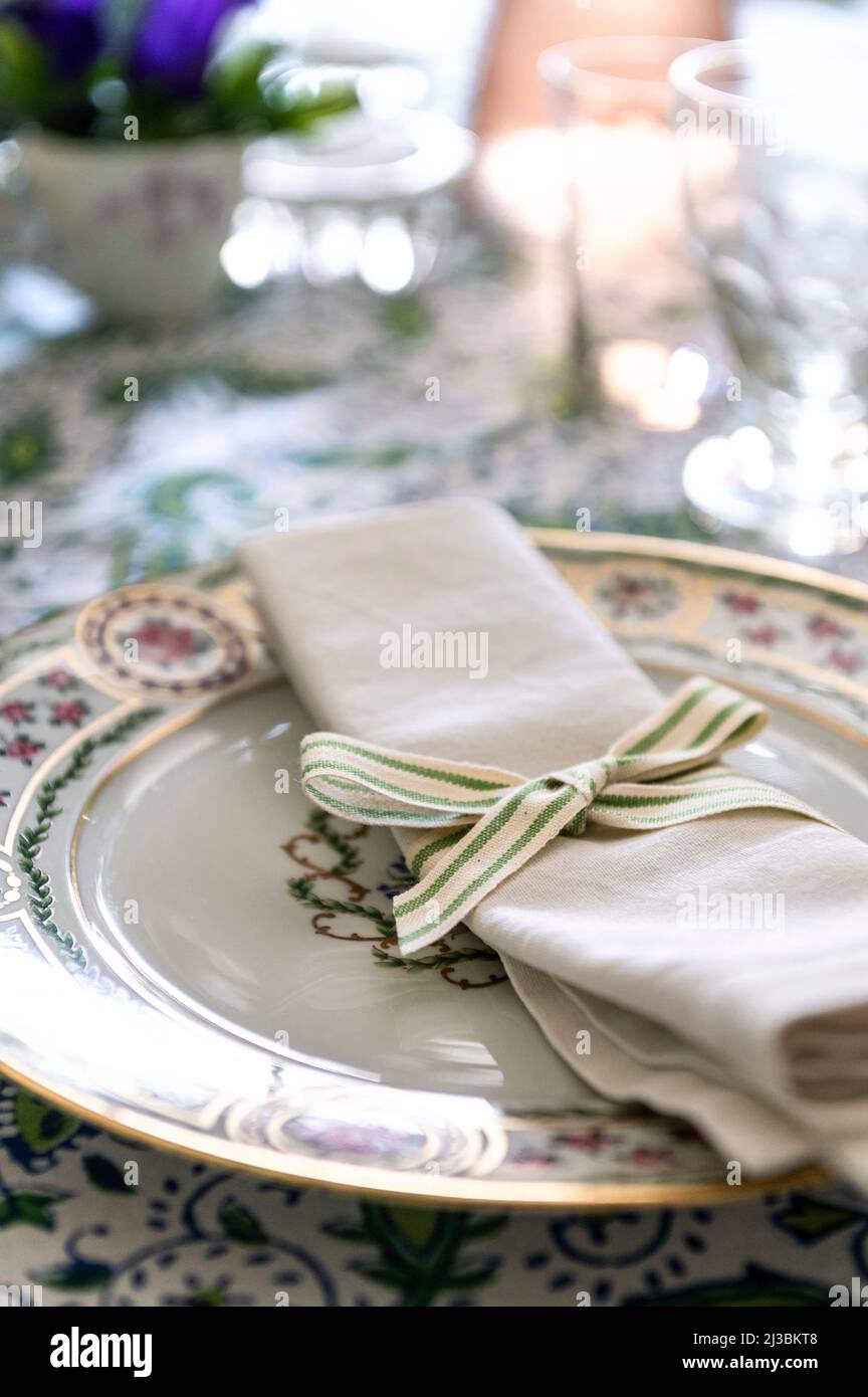 LInen napkin tied with ticking on side plate in 17th century Suffolk home, UK Stock Photo