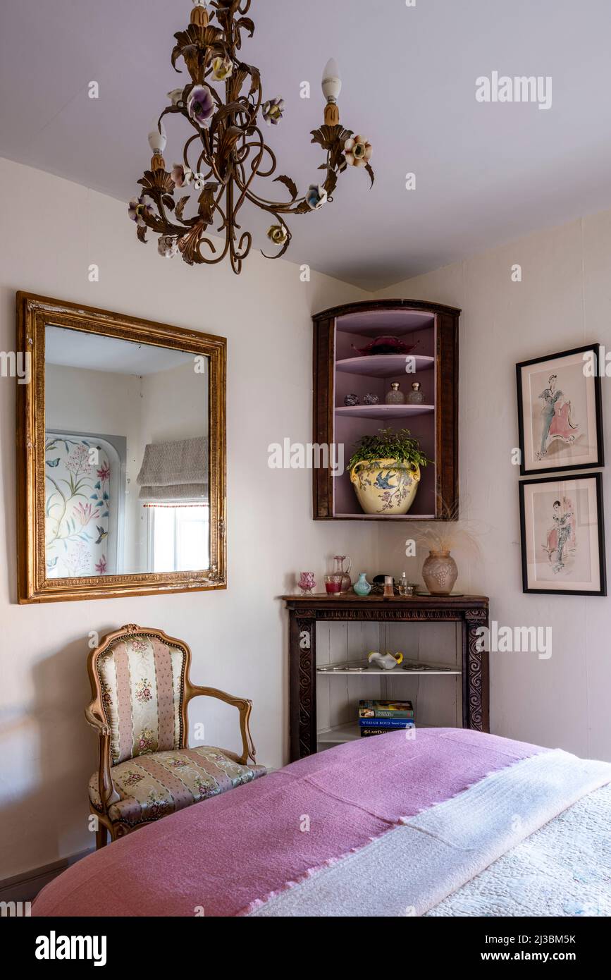 Corner shelving and gilt framed mirror in 17th century Suffolk home, UK Stock Photo