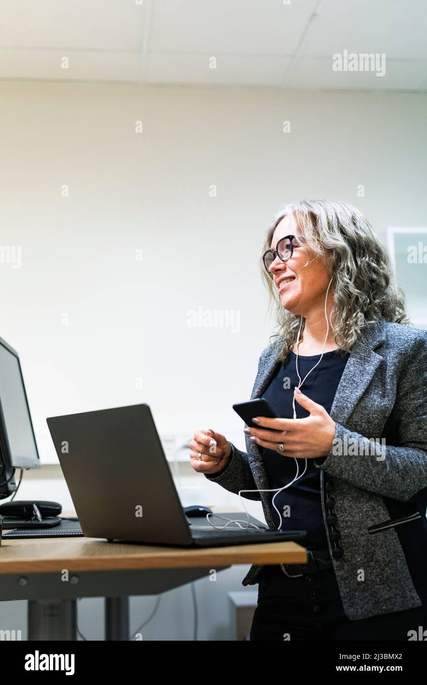 Businesswoman using laptop and smart phone Stock Photo