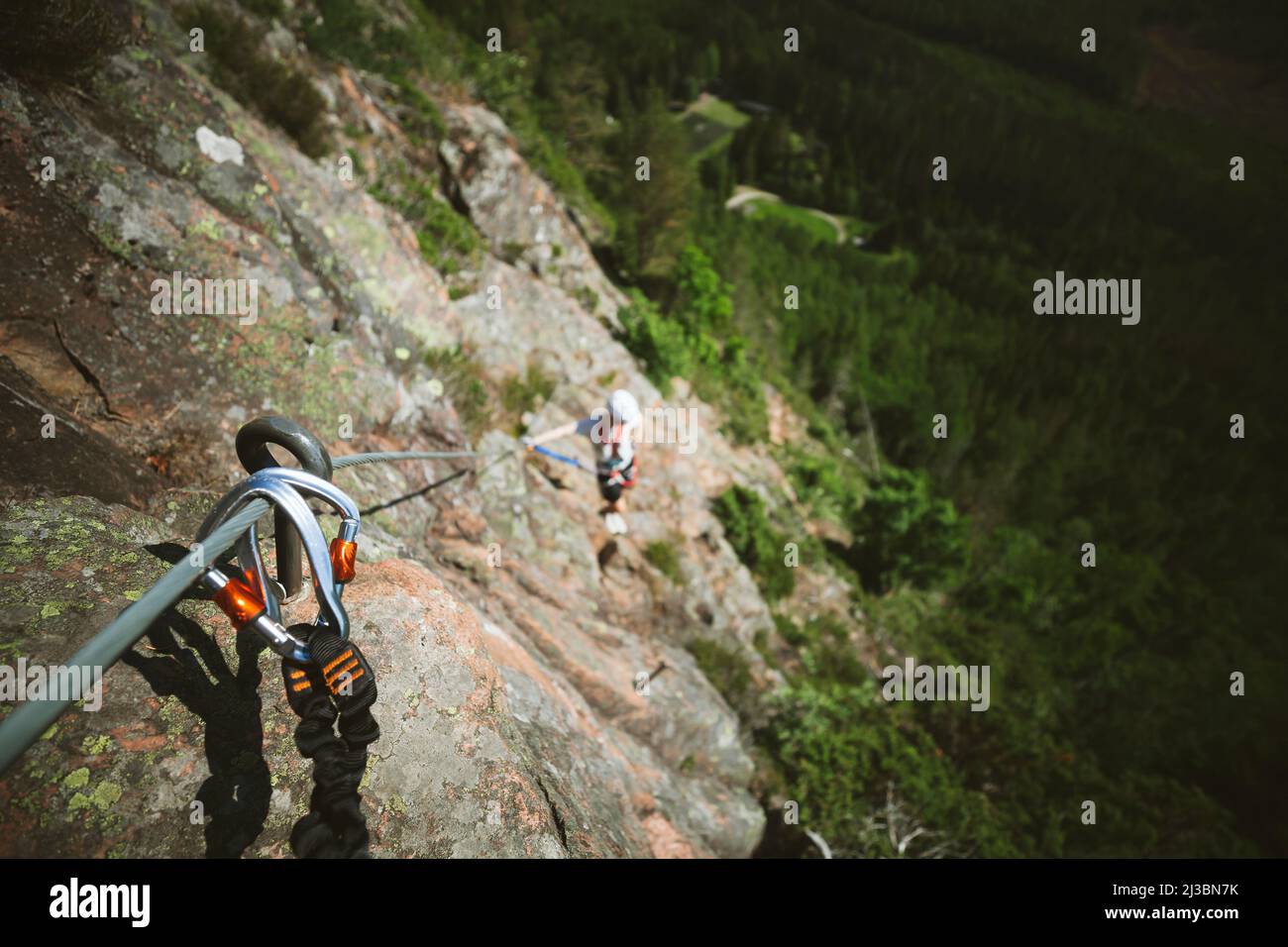 Man mountain climbing with equipment Stock Photo