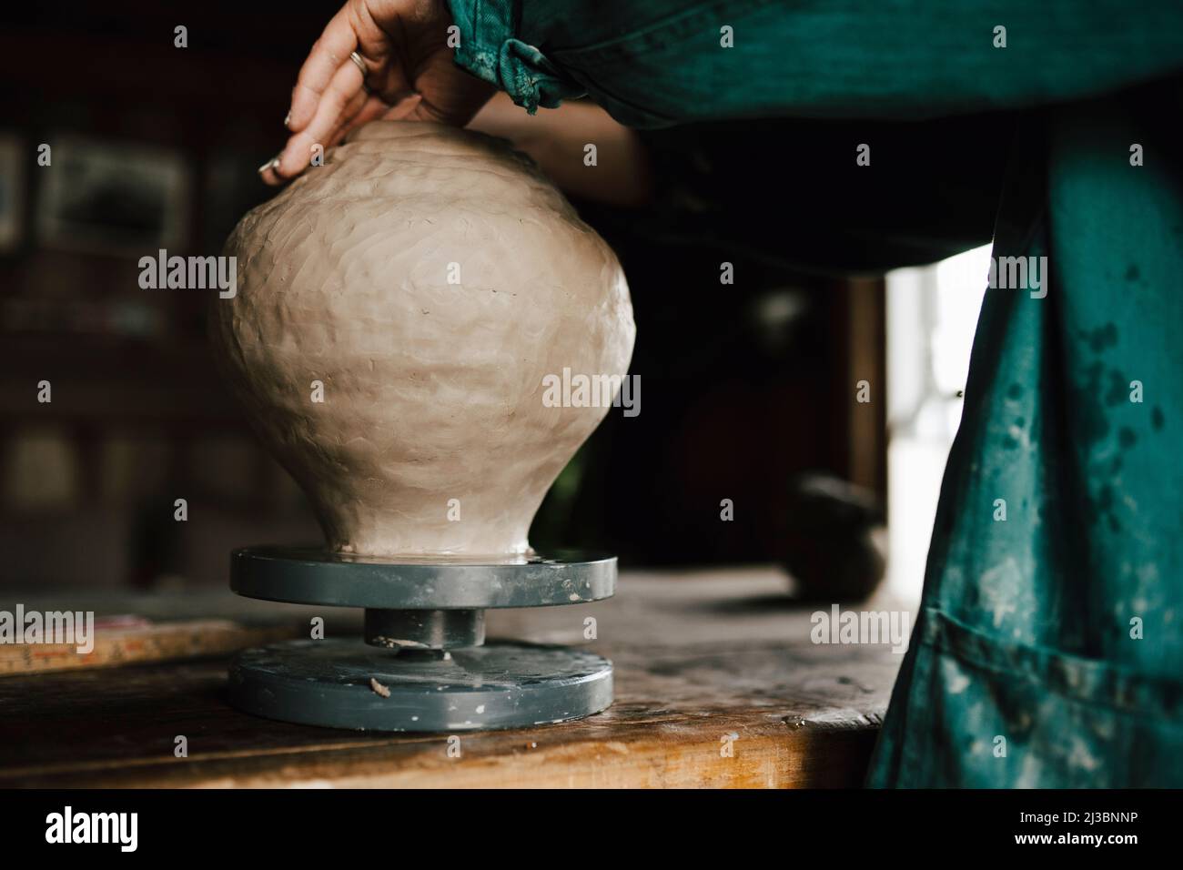 Female potter making vase in workshop Stock Photo
