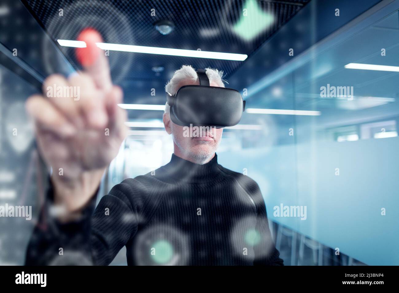 Senior man in virtual reality headset using advanced technology Stock Photo