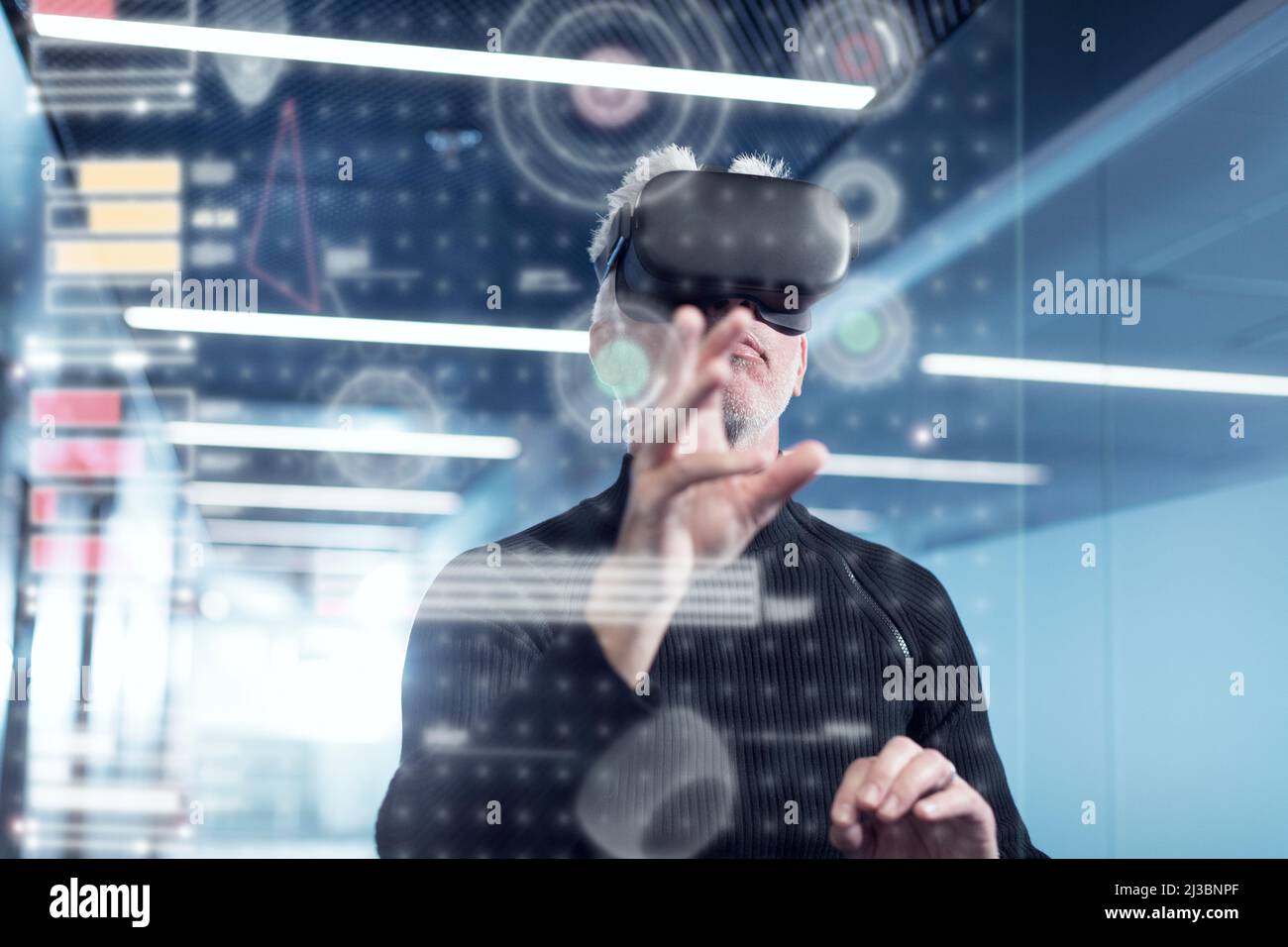 Senior man in virtual reality headset using advanced technology Stock ...
